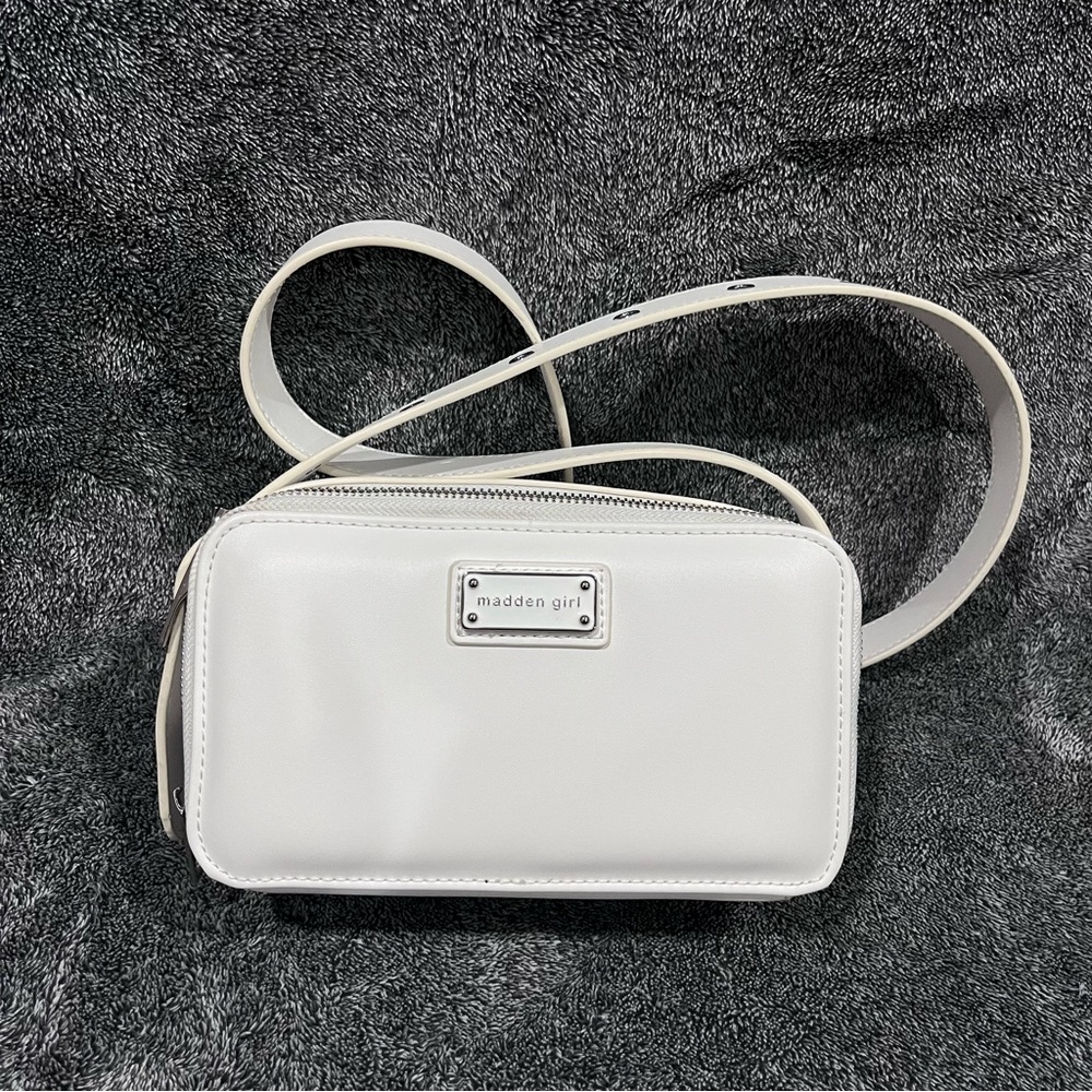 Madden Girl white crossbody bag featuring a rectangular shape and a logo plate